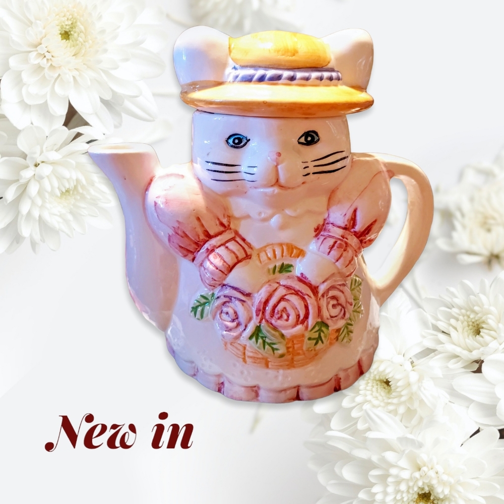 Vintage Cat Shaped Teapot Holding a Basket of Pink Roses